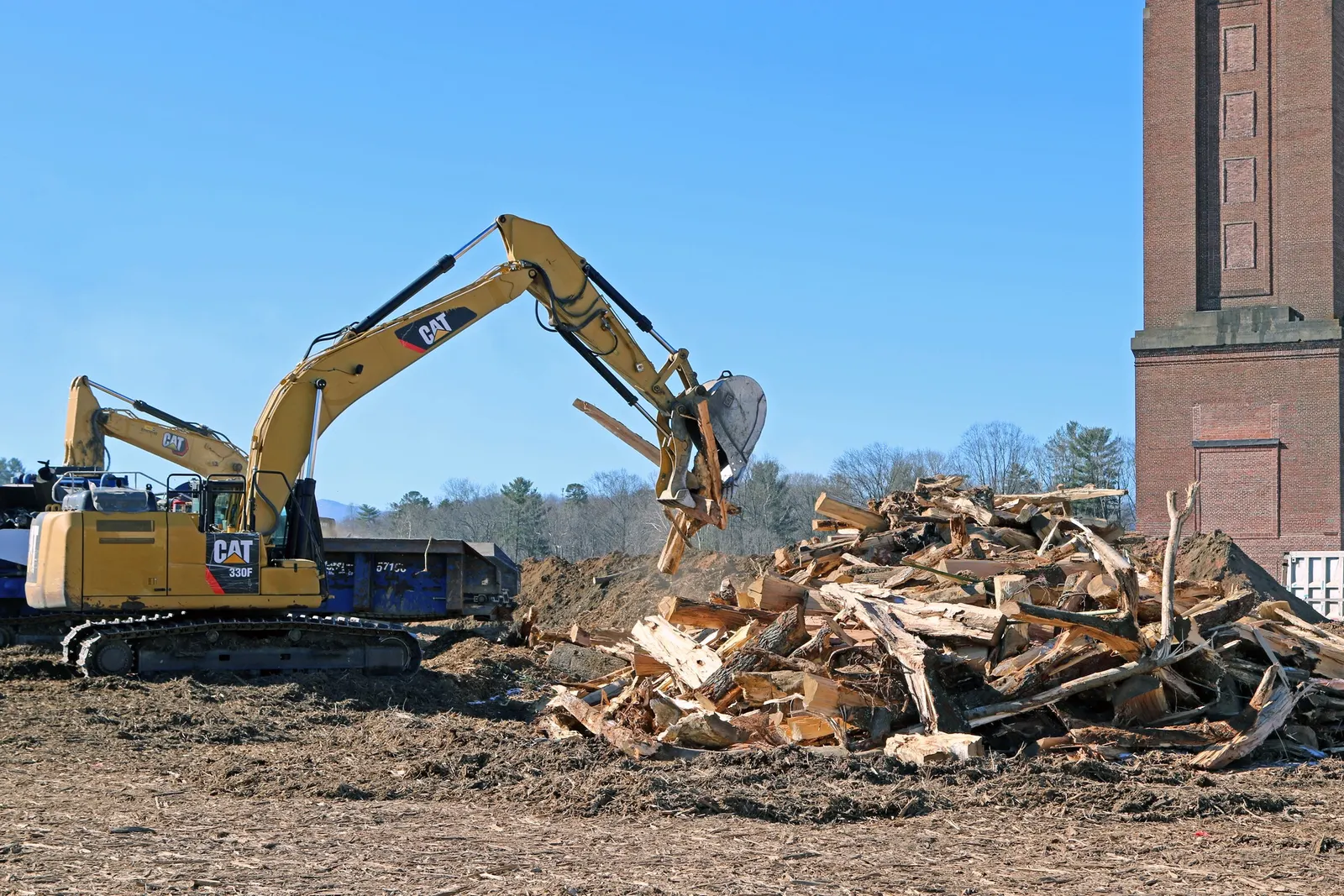 Contractors prepare to load vegetation debris into a woodchipper at Enka Tower in Buncombe County, North Carolina Jan